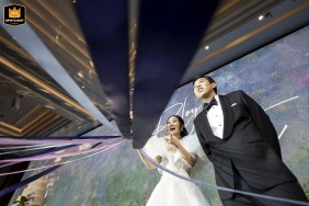 Graphic low-angle shot of the bride and groom at Conrad Bangkok during bouquet time.